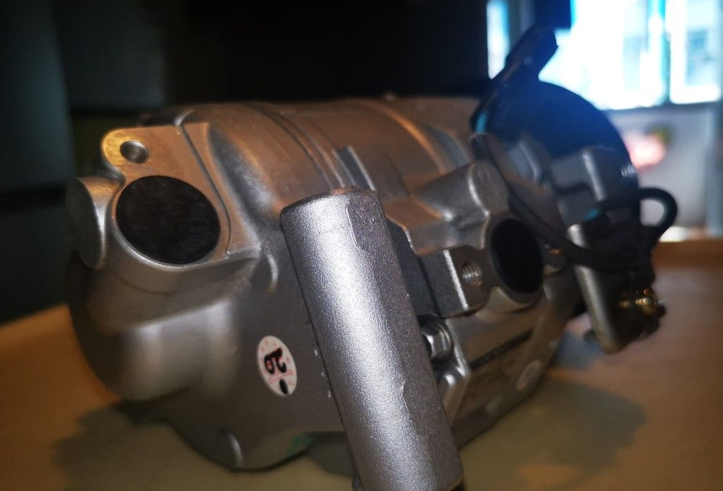 Automotive A/C compressor housing and pulley assembly