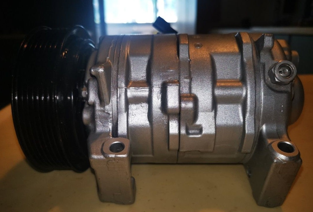 Automotive A/C compressor refrigerant ports and mounting points