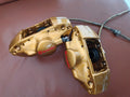 Two gold Brembo brake calipers pictured together
