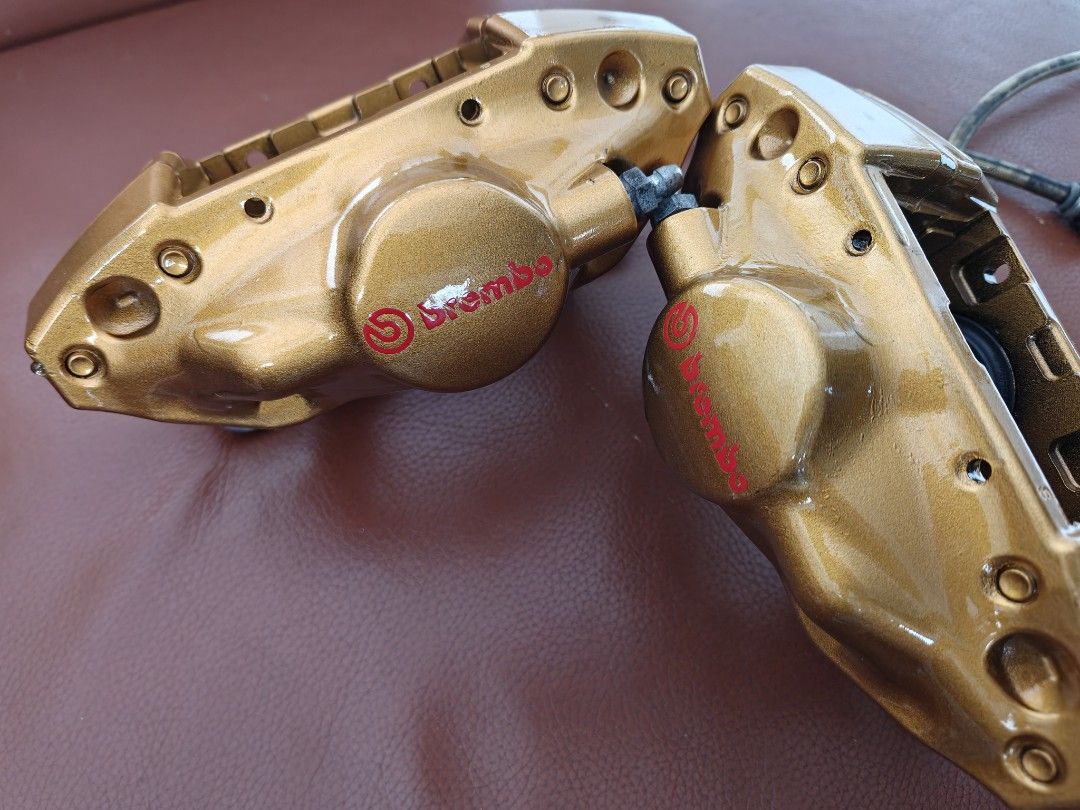 Close-up of gold Brembo caliper branding and outer faces