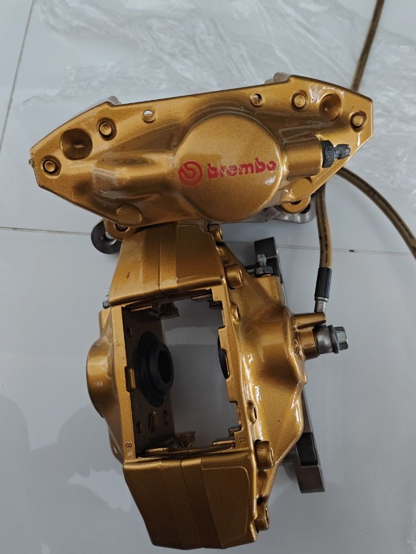 Gold Brembo brake calipers showing piston openings