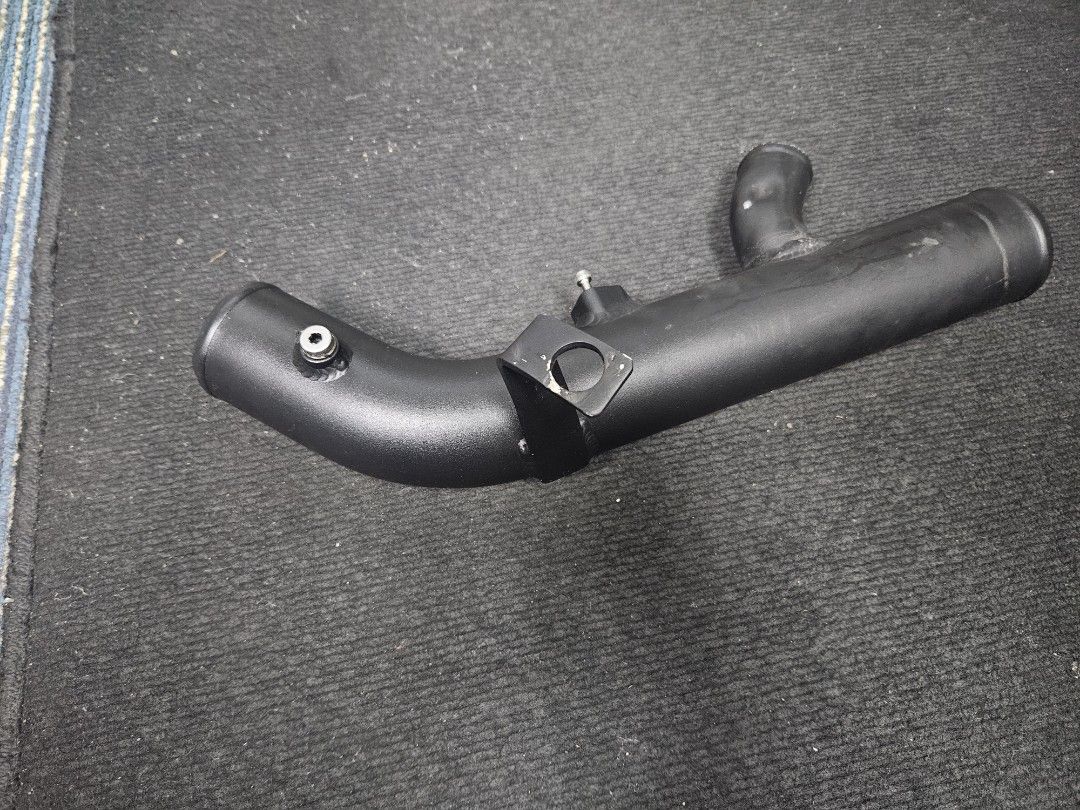 Black charge pipe showing curved tube and branch outlet