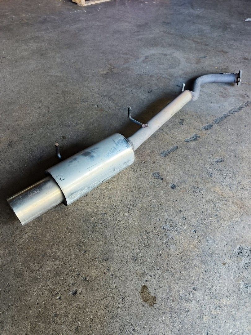 HKS exhaust muffler and pipe assembly, angled view