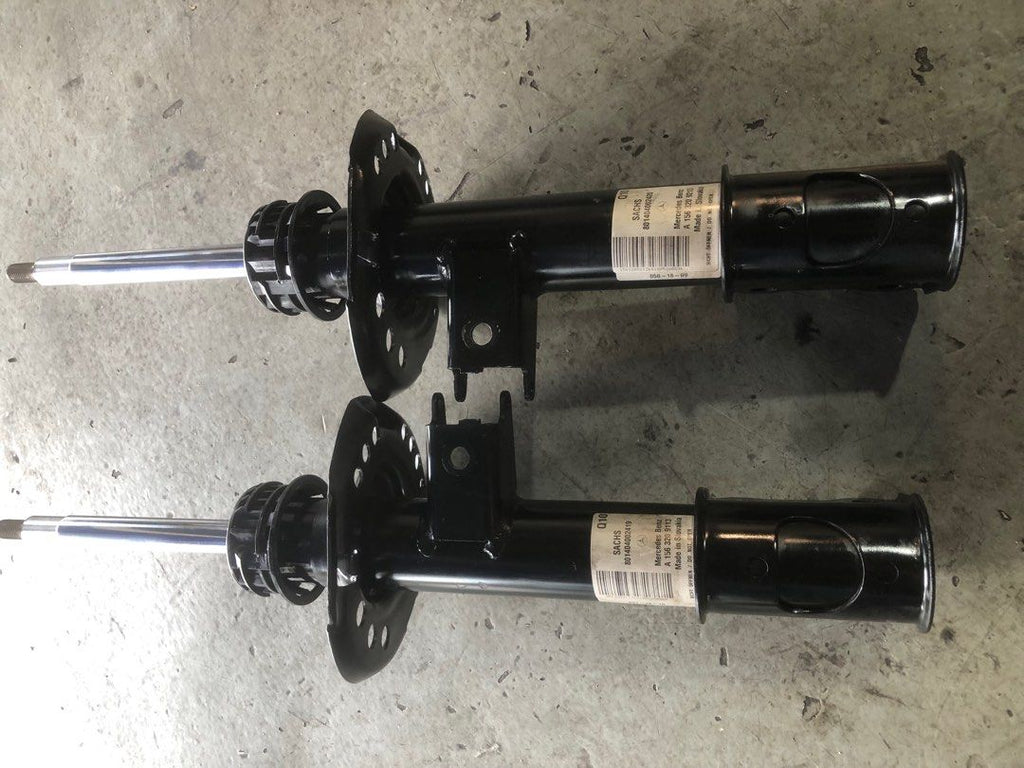 Two GLA W156 front shock absorbers with identification labels