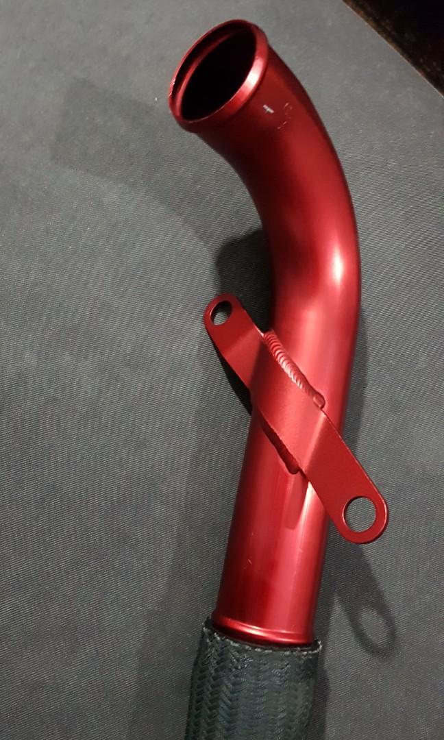 Close-up of red Mitsubishi Evo X upper intercooler pipe and mounting tab