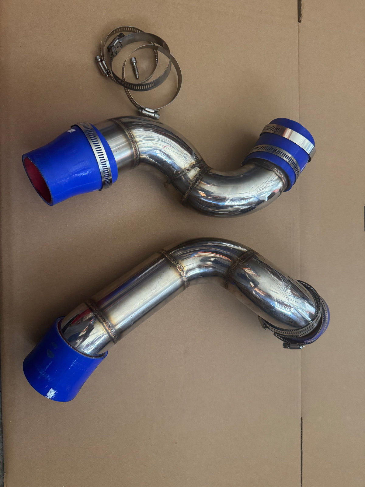 Two W204 C180 intercooler charge pipe sections with blue couplers